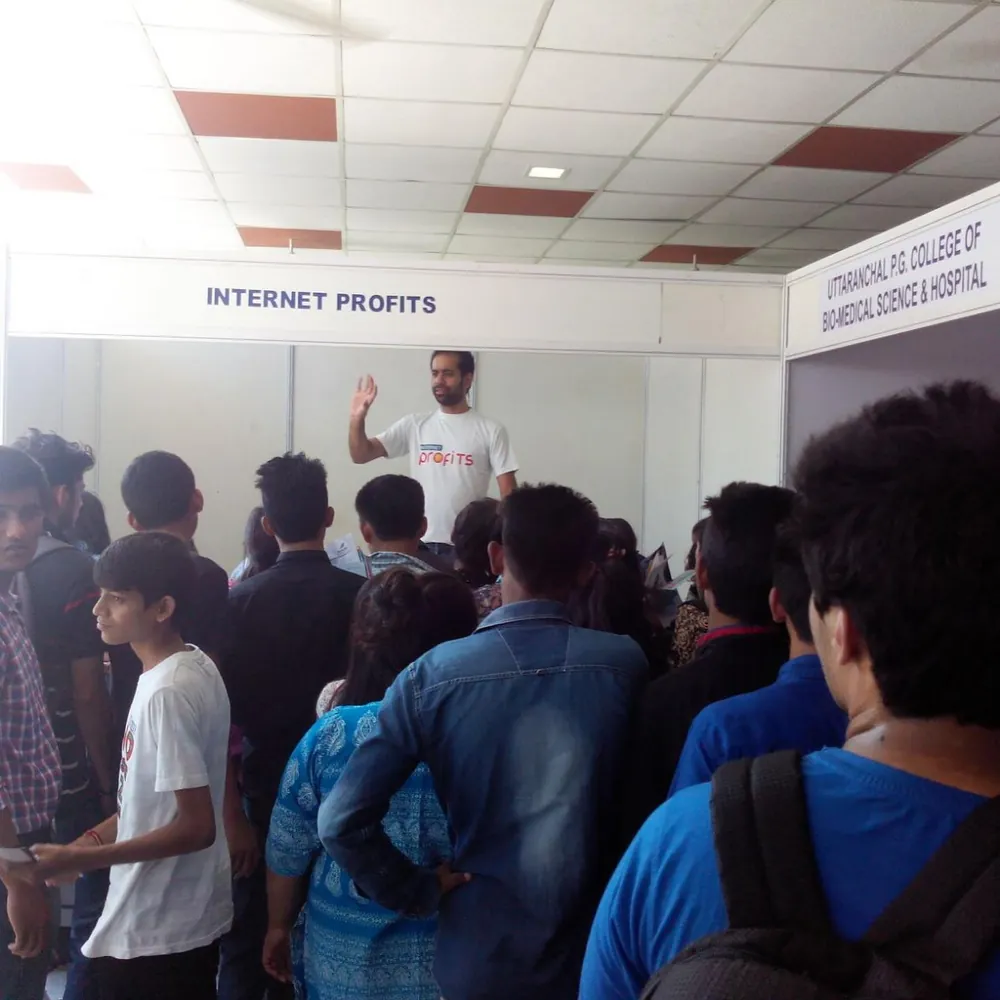 Photo: Gaurav speaking to a crowded hall under an Internet Profits banner